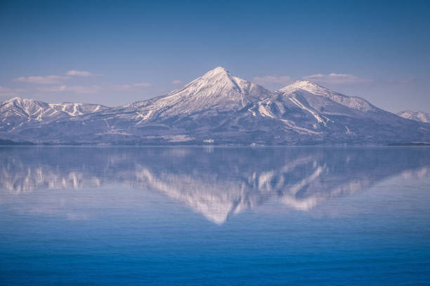 Mt.Bandai with reflection at Inawashiro Lake in spring stock photo