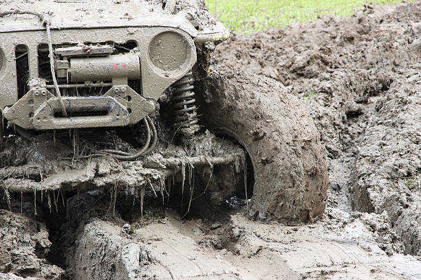 Muddy Off-road vehicle driving through mud on 4x4 Offroad race stock photo