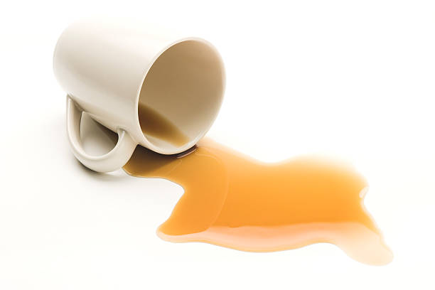 Mug knocked over with spilt coffee on white background Cup of coffee spilled. spilling stock pictures, royalty-free photos & images