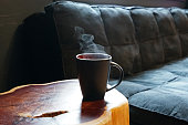 Ceramic cup of hot beverage in living room