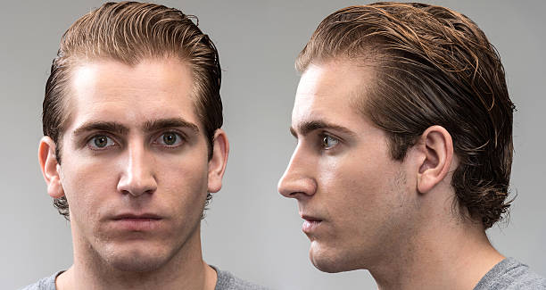 Mug Shot (real people) Mug shot of a young caucasian man looking at the camera on gray background (profile and front view) blank expression photos stock pictures, royalty-free photos & images
