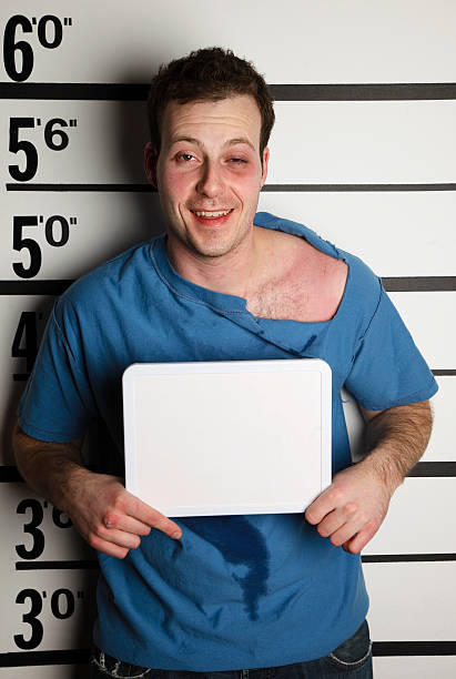 Mugshot of an Arrested Man A mugshot of a man who has been in a fight. black eye stock pictures, royalty-free photos & images