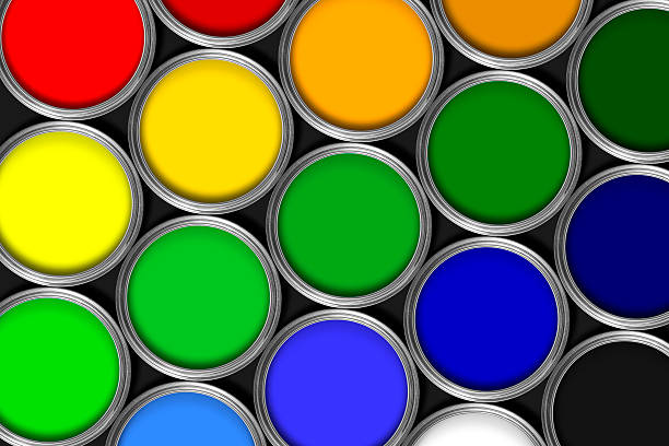 Mulit colored tins of paint in rows against black stock photo