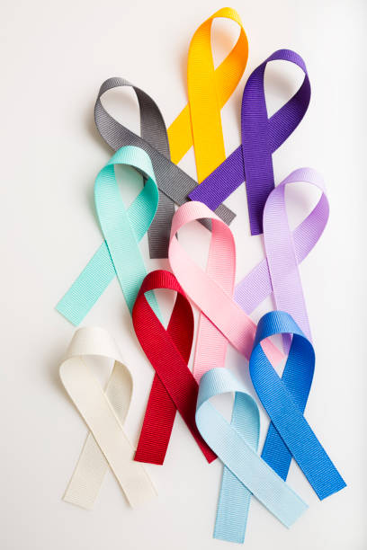 Multi colored cancer ribbons Proudly worn by patients, supporters and survivors for world cancer day. Bringing awareness to all types of cancer. stock photo