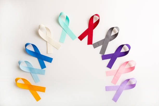Multi colored cancer ribbons Proudly worn by patients, supporters and survivors for world cancer day. Bringing awareness to all types of cancer stock photo