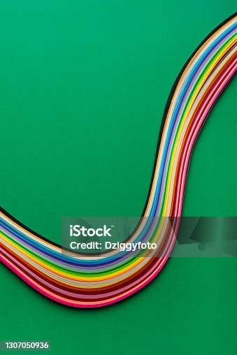 istock Multi Colored Quilling Paper Lying On Green Paper 1307050936