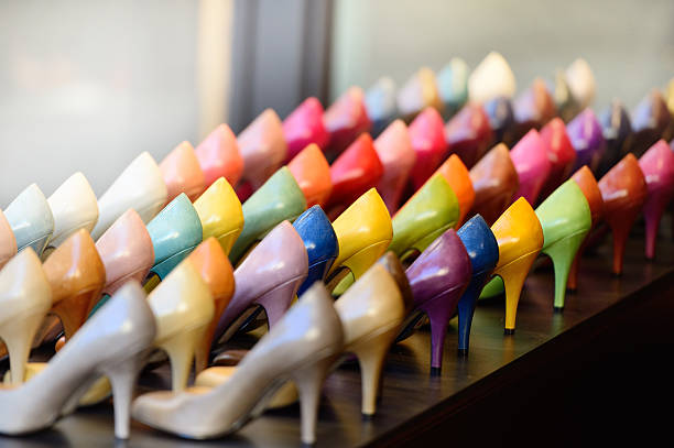Multi colored womens shoes in shop window display stock photo