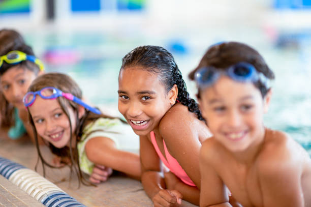 Multi ethnic children at a group swimming lesson stock photo
