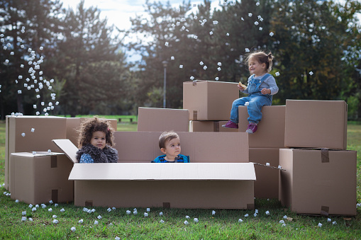 Multi Ethnic Children Playing With Cardboard Boxes Stock Photo ...