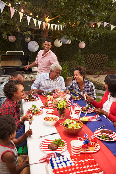 multi generation black family at 4th july barbecue, vertical - grandparents vertical imagens e fotografias de stock