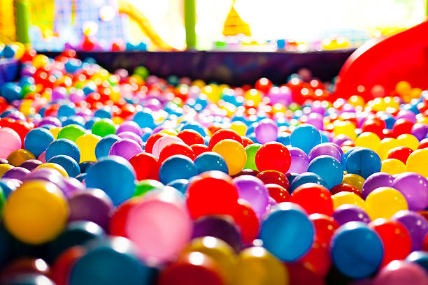 Multicolored balls in a playground Multicolored balls in a playground indoor playground stock pictures, royalty-free photos & images