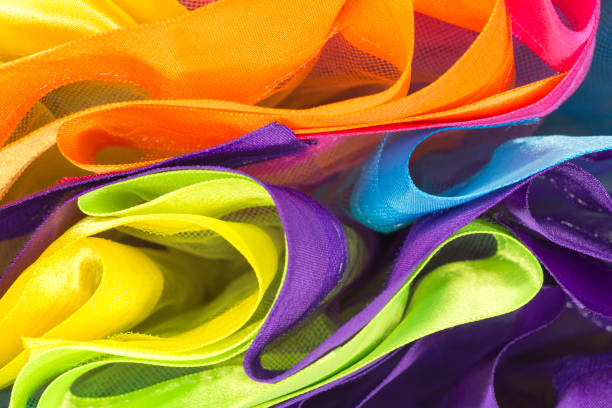 Multicolored fabrics with ribbons as abstract background stock photo