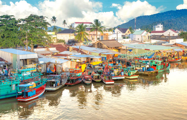 Multicolored fishing boats Multicolored fishing boats at the pier in the fishing village fishing village stock pictures, royalty-free photos & images