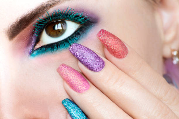 Multi-colored make-up and manicures. stock photo