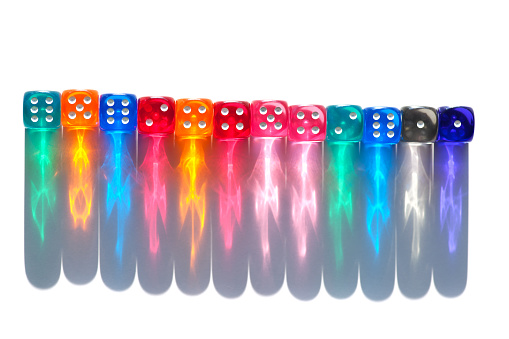 multicoloured dice with shadows