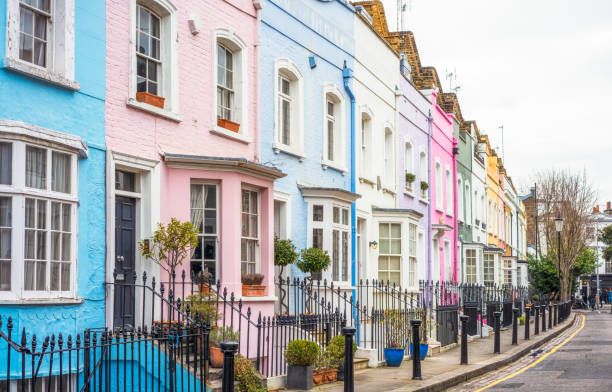 Multi-coloured street of houses in Chelsea, London A street in the Chelsea area of central London, with each house painted a different pastel colour. chelsea stock pictures, royalty-free photos & images