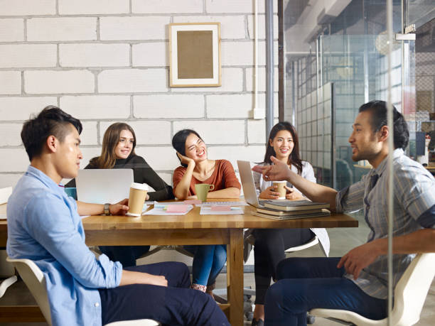 multiethnic business team meeting in office a team of multinational people discussing business in glass meeting room. china east asia photos stock pictures, royalty-free photos & images