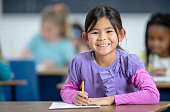 istock Multi-Ethnic Elementary Students Writing in Class 1342280650