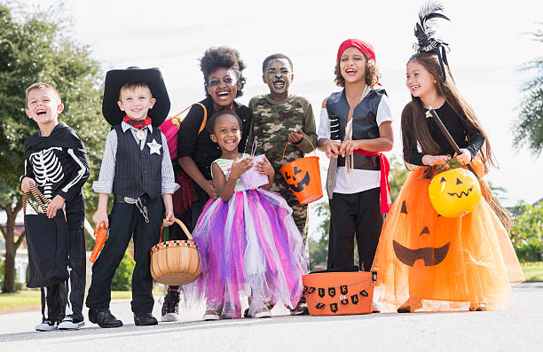 Multi-ethnic group of children in halloween costumes A multi-ethnic group of seven children wearing halloween costumes. They are mixed ages, from 3 to 10 years old, ready to go trick or treating. costume photos stock pictures, royalty-free photos & images
