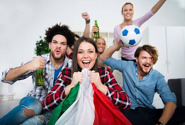 multiethnic group of friends watching a football game - soccer news 個照片及圖片檔