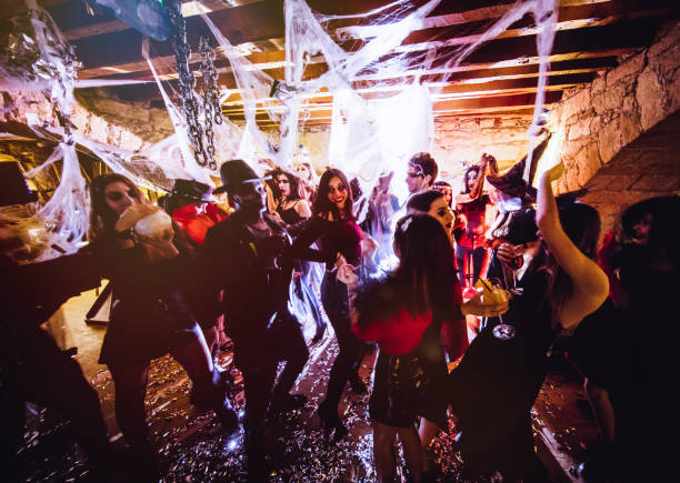 multi-ethnic people in halloween costumes having fun at dungeon nightclub - discoteca danca imagens e fotografias de stock