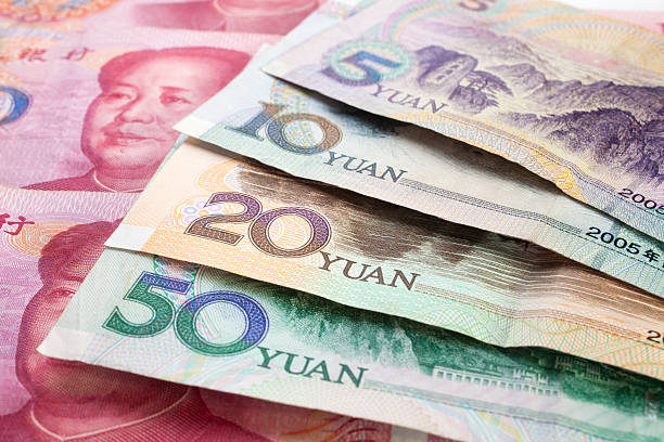 Multiple Chinese Yuan Renminbi notes Background of Chinese currency. chinese currency stock pictures, royalty-free photos & images