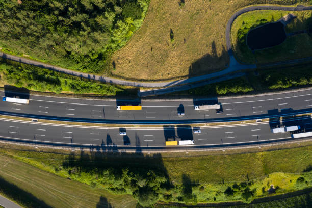 flera lane highway med semi last bilar från ovan - european highway drone bildbanksfoton och bilder