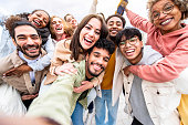 istock Multiracial friends group taking selfie portrait outside - Happy multi cultural people smiling at camera - Human resources, college students, friendship and community concept 1356348368