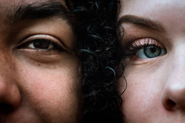 Multiracial Young Adult Couple Portrait A close up photo of a teenage African America man and a Caucasian woman face to face. eye close up stock pictures, royalty-free photos & images