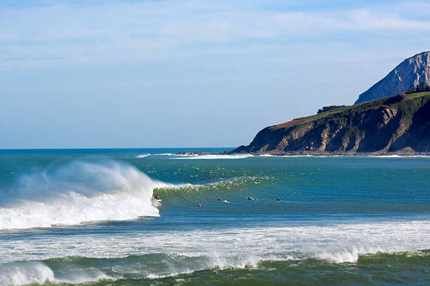 Mundaka surfer on barreling wave in Mundaka headland stock pictures, royalty-free photos & images
