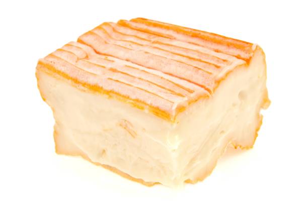 Munster cheese piece of Munster cheese on a white background muenster cheese stock pictures, royalty-free photos & images