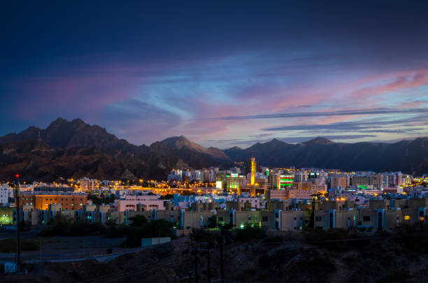 Muscat skyline in the evening Illuminated buildings during an evening in Muscat, Oman with beautiful sky in the background oman stock pictures, royalty-free photos & images