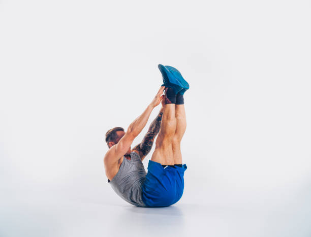 Muscular man doing abdominal workout stock photo