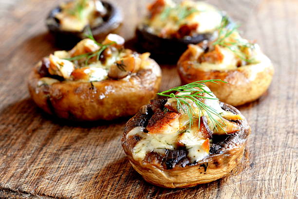 Mushroom caps stuffed with cheese and meat stock photo
