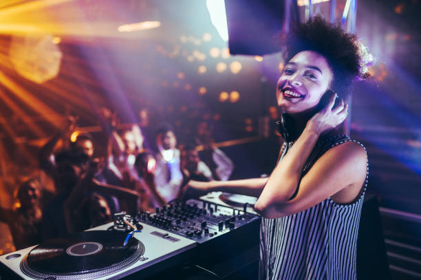 Music is her passion Shot of a female DJ playing music at a nightcub club dj stock pictures, royalty-free photos & images