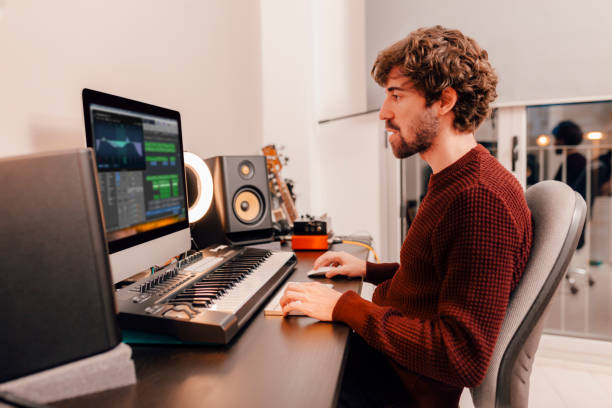 Music producer working in recording studio at home stock photo