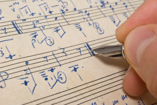 sheet music being written by hand