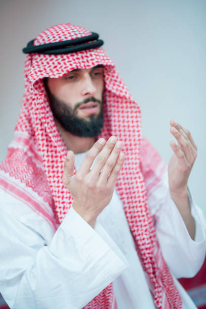 Handsome Younger Muslim Arabic man praying in mosque
