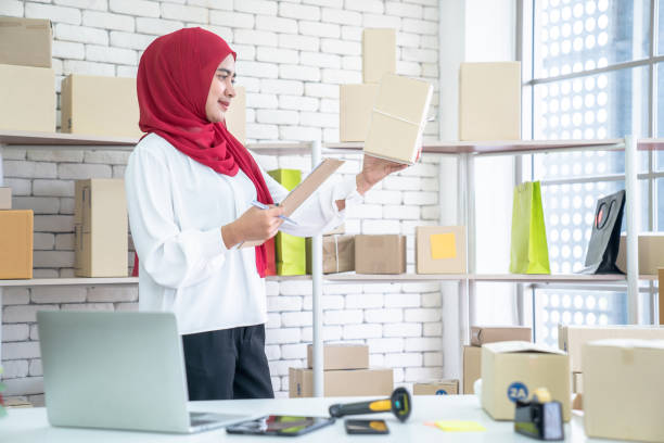 Muslim business woman working in office, Modern Muslim Business Woman, SME, Small business, Online trading and shipping services. stock photo