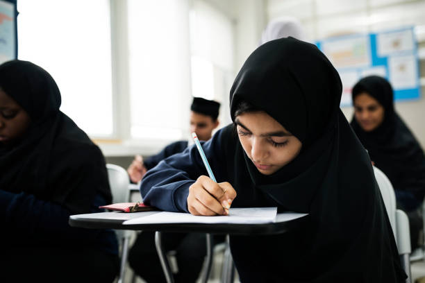 Muslim children studying in classroom Muslim children studying in classroom indonesian girl stock pictures, royalty-free photos & images