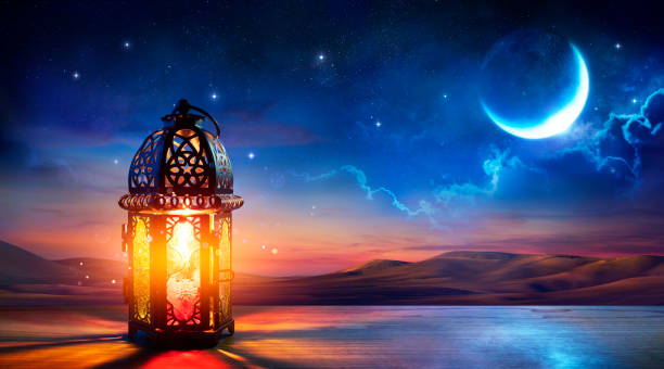 Muslim Holy Month Ramadan Kareem - Ornamental Arabic Lantern With Burning Candle Glowing At Evening stock photo