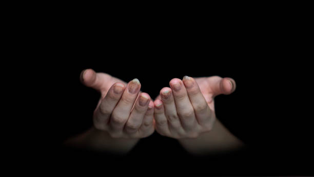 Muslim woman Praying hands with faith in religion and belief in God on dark background.  prayer request stock pictures, royalty-free photos & images