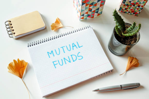 mutual fund written in notebook stock photo