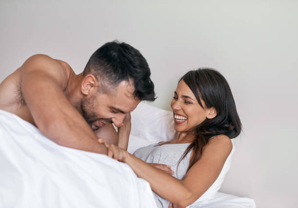 My own personal alarm Cropped shot of an affectionate young married couple in bed at home tickling beautiful women pictures stock pictures, royalty-free photos & images