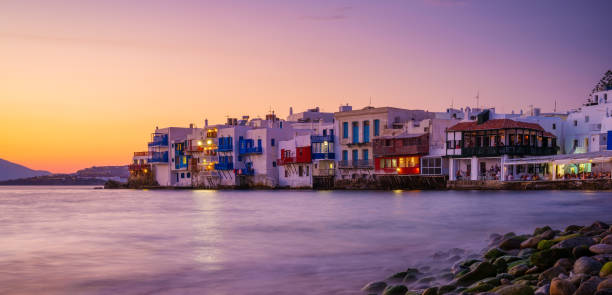 Mykonos, Greece. View of a traditional house in Mykonos. The area of Little Venice. Seascape during sunset. Sea shore and beach. Photo for travel and vacation. stock photo