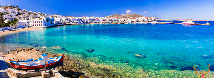 Mykonos island. Greece summer holidays. Panorama of old port in downtown with turquoise sea and beach. Cyclades.