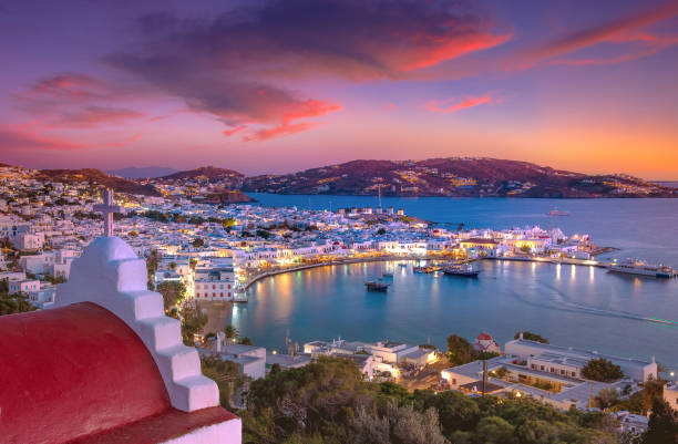 Mykonos port with boats and windmills at evening, Cyclades islands, Greece stock photo