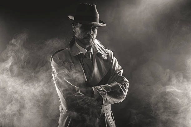 Mysterious man waiting in the fog Mysterious man waiting with arms crossed in the fog, 1950s style film noir gangster stock pictures, royalty-free photos & images