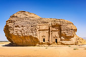 Stock photograph of rock-cut tombs of Mada'in Saleh, from the time of the Nabatean kingdom, UNESCO world heritage site near Al Ula, Saudi Arabia.