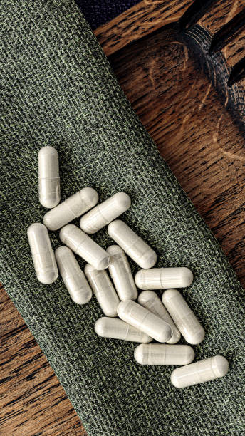 n-acetyl cysteine (NAC) supplement capsules  on burlap rag. immune prevention care concept stock photo
